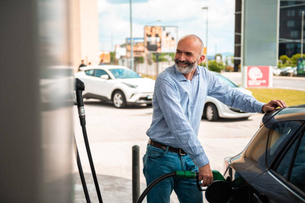 istock Senior Man Pumping Gas at Service Station 2153708921