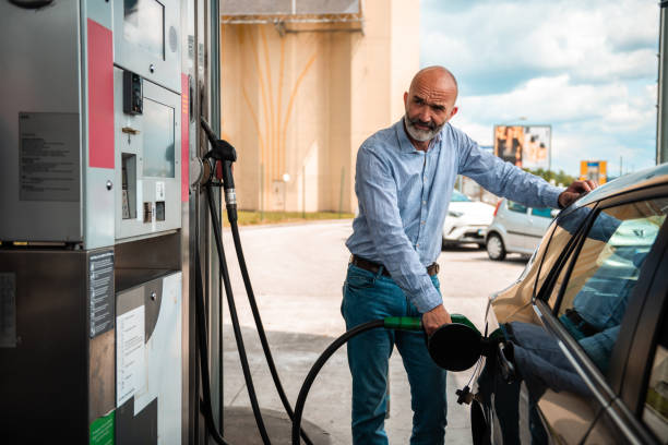 istock Senior Man Refueling Vehicle at Service Station 2153708943