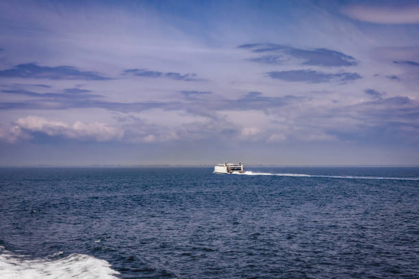 istock Seascape with a white ferry in the distance and waves. 2153716147