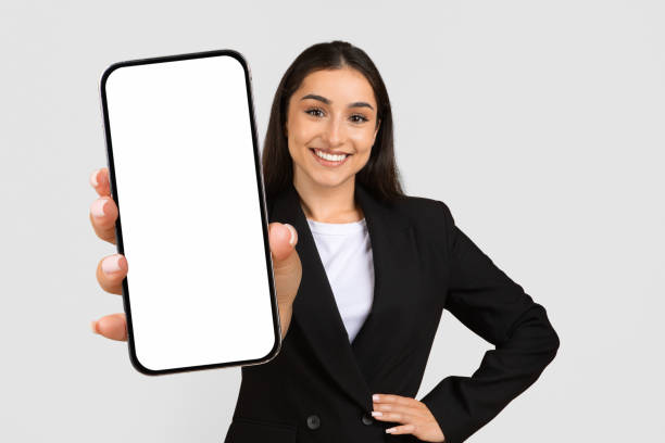 Confident businesswoman presenting blank smartphone screen