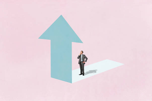 istock Man Looks Up At Arrow 2153725077