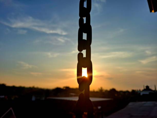 silhouette of sunlight with hanging chains