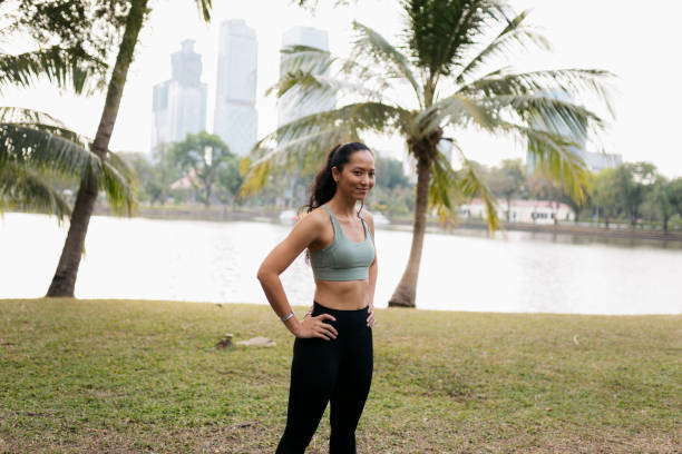 istock Young woman runner taking break from workout at park 2153725762