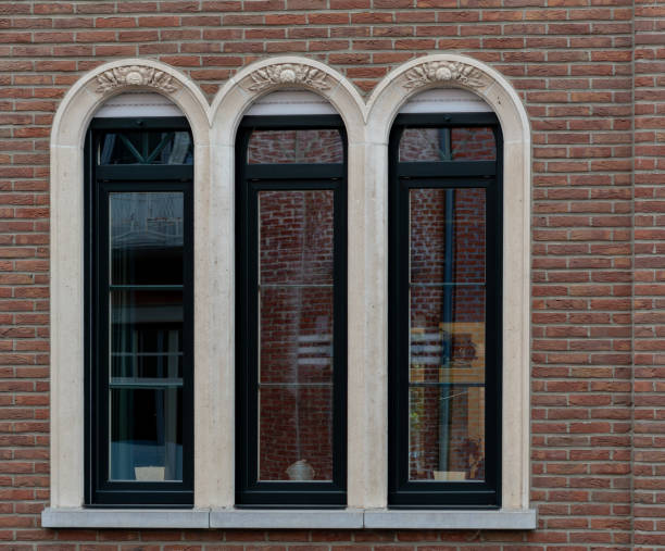 istock Gothic style arched window,brick wall with windows, windows on the red wall, windows on red brick in an abandoned building 2153726947