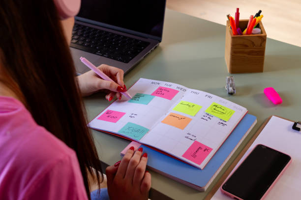 istock Woman planning weekly schedule with colorful calendar 2153727918