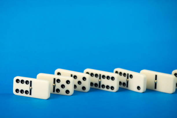 Dominoes with blue background, copy space and various angles. White Bones Board Game.