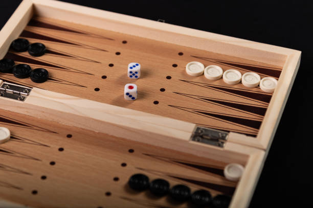 istock Board for playing backgammon with pieces and dice on a black background. 2153728993