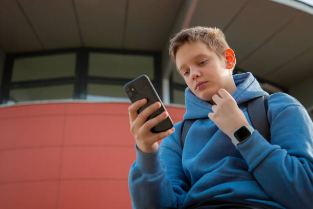 istock Modern Youth: Teen Boy Messaging Friends 2153731844