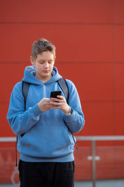 istock Active Learning: Teen Boy Engaged in Typing 2153731935
