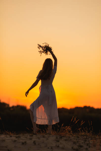 istock Female silhouette against sunset background. 2153732698