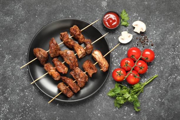 istock Delicious shish kebabs served on grey textured table, flat lay 2153733084