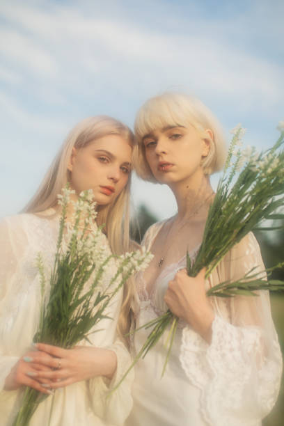 Two young women resting in the meadow.