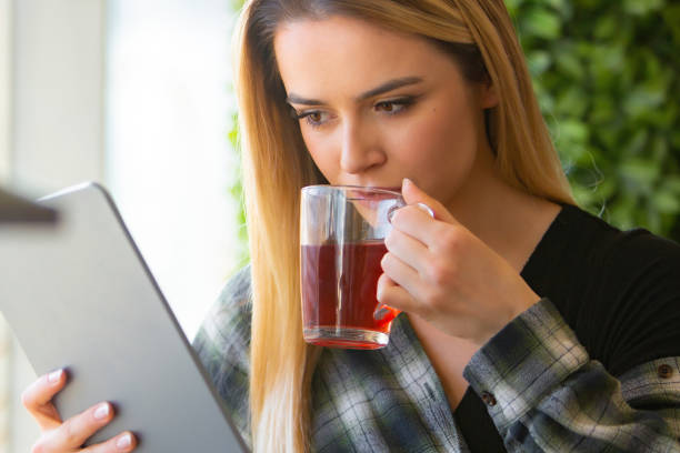 istock Young Woman Enjoying Tea and Digital Escape 2153738081