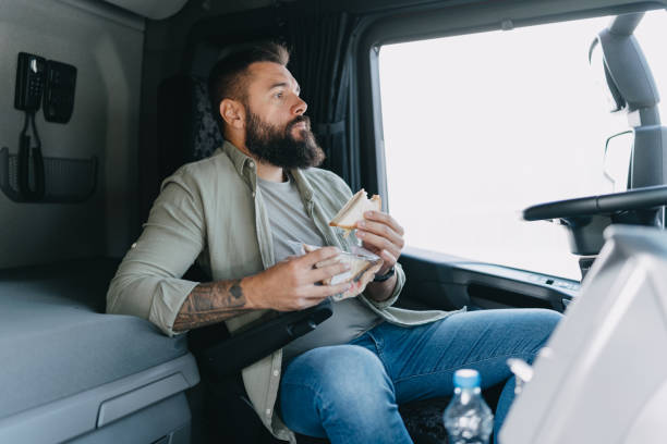 istock Trucker counting money inside his vehicle 2153738943