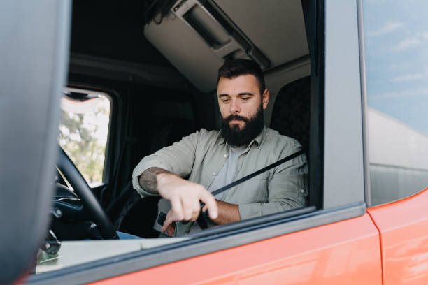 istock Bearded truck driver inside vehicle cab 2153739019