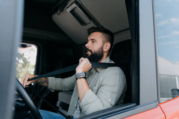 istock Truck driver buckling up before driving 2153739023