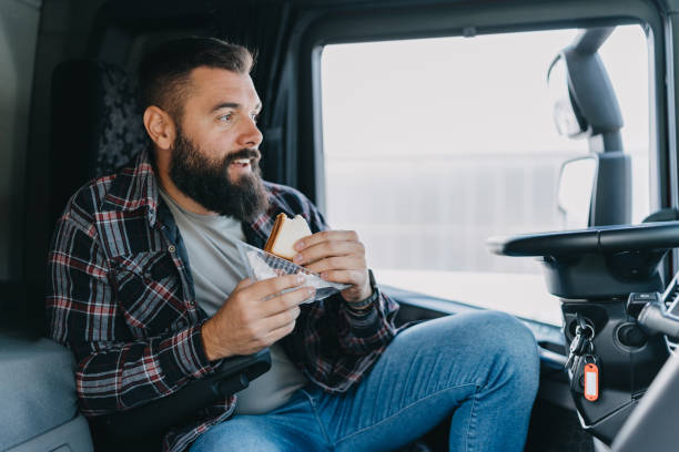 istock Bearded truck driver eating a sandwich 2153739091