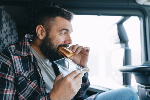 Man eating in truck cabin during break