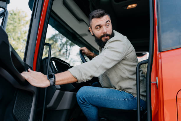 istock Man getting out of a modern red van 2153739169