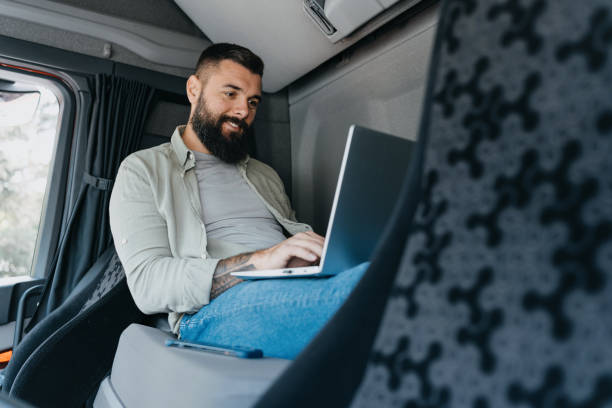 istock Bearded man using laptop in truck cabin 2153739497