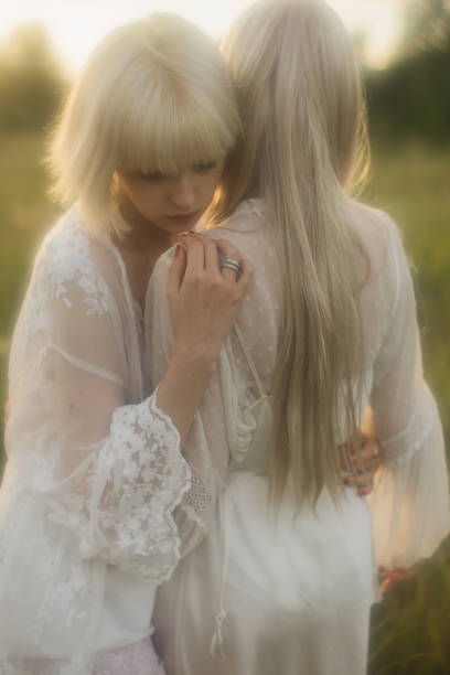 Two young women resting in the meadow.