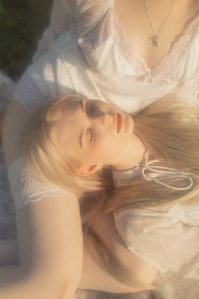 Two young women resting in the meadow.
