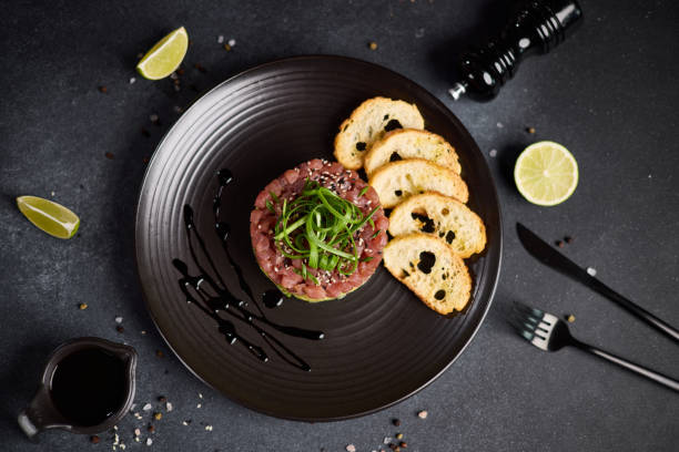 istock Tuna and avocado tartare on a dark ceramic plate 2153741209