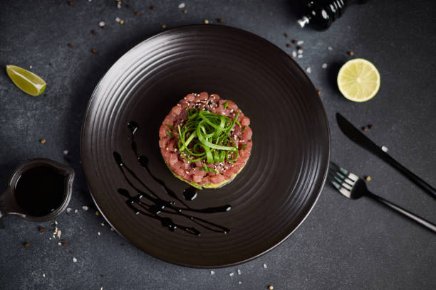 istock Tuna and avocado tartare on a dark ceramic plate 2153741227