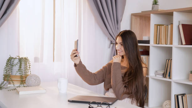 istock Virtual connection woman home cell phone video 2153741328