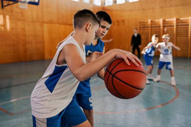 istock A junior basketball team is practicing game playing at indoor court. 2153741600