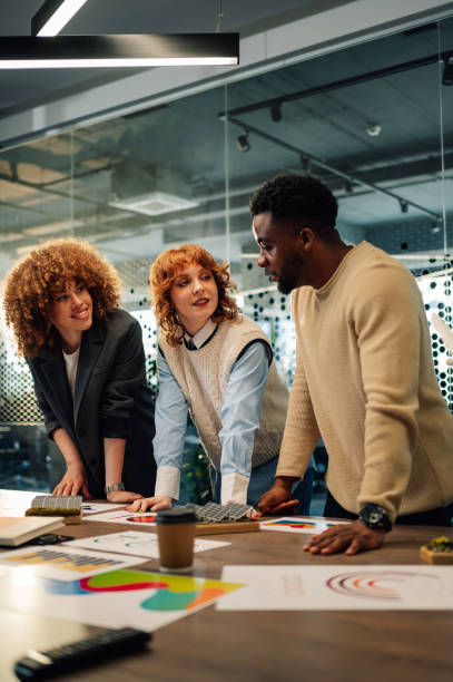 istock Interracial ecology experts at boardroom discussing renewable energy. 2153741649