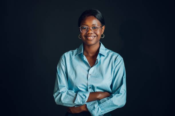 istock Multicultural professional businesswoman smiling isolated on dark wall 2153741685