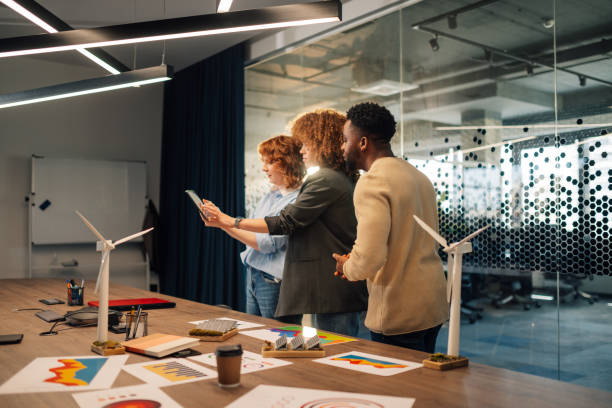 istock Diverse colleagues working on sustainable project with tablet at office 2153741694
