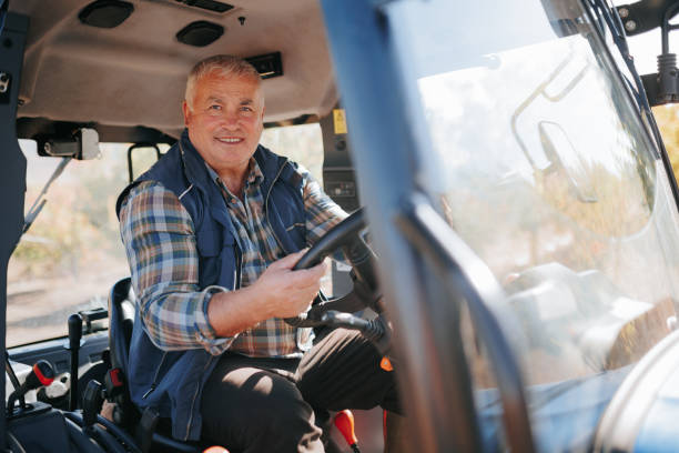 istock In Control Elderly Farmer Operating Tractor in Agricultural Setting 2153742078