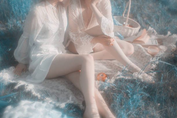 Two young women resting in the meadow.
