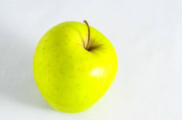 a green apple on a table