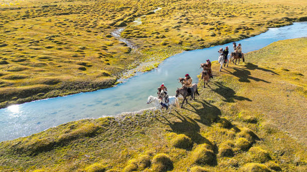 istock group of Kazakh eagle hunters riding horses along river Bayan Olgii, West Mongolia 2153744516