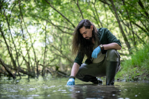 istock A female environmentalist researcher collects water samples in the river 2153745071