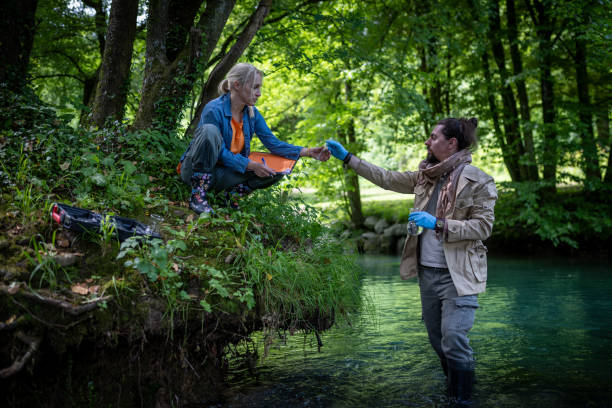 istock Environmentalists and researchers collect water samples in the river 2153745129