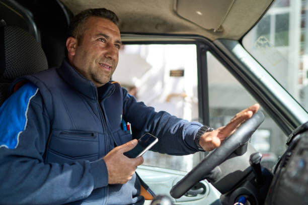 istock The smiling courier is preparing to move on in his vehicle after delivering the package 2153745221