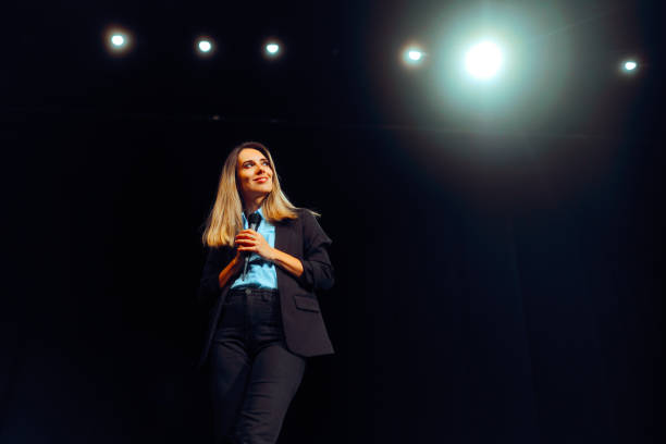 istock Woman Reading a speech Taking Questions on Stage 2153745653