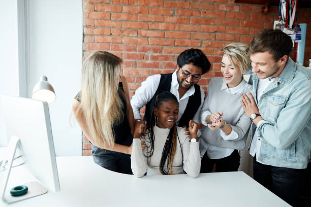 istock staff is congratulating their colleague with a new post, position 2153747211