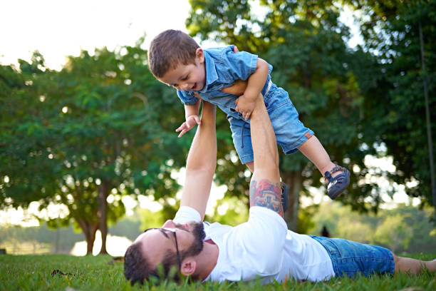 istock Dad and his son playing in the grass 2153747582