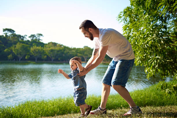 istock Dad and his son playing in the grass 2153747661