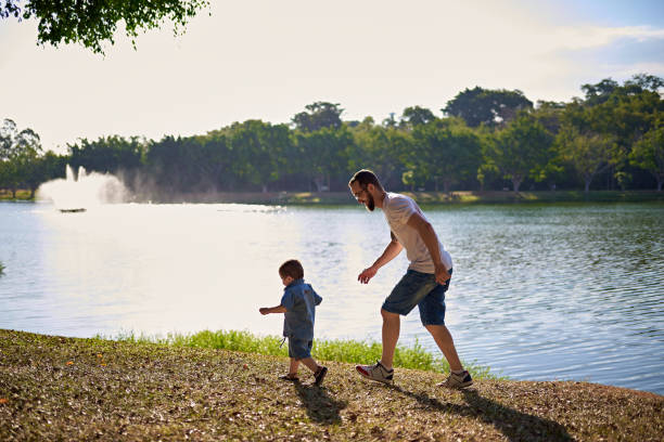 istock Dad and his son playing in the grass 2153747692
