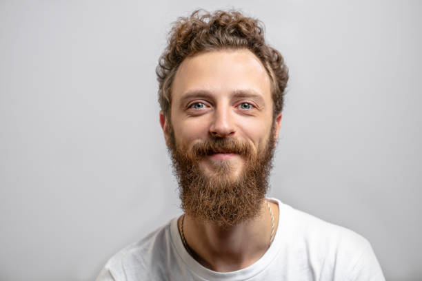 istock Handsome hipster man with beard smiling at camera over white background. 2153748749
