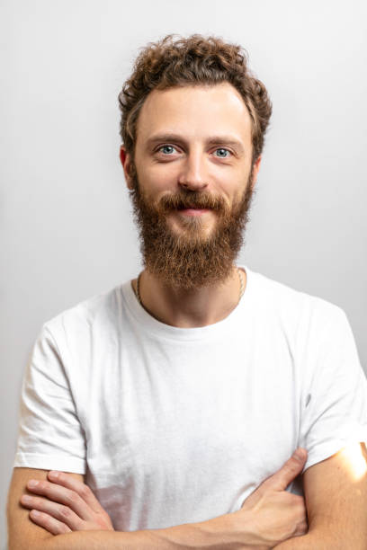 istock Handsome hipster man with beard smiling at camera over white background. 2153748763
