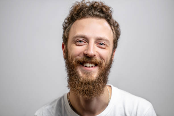 istock Handsome hipster man with beard smiling at camera over white background. 2153752718