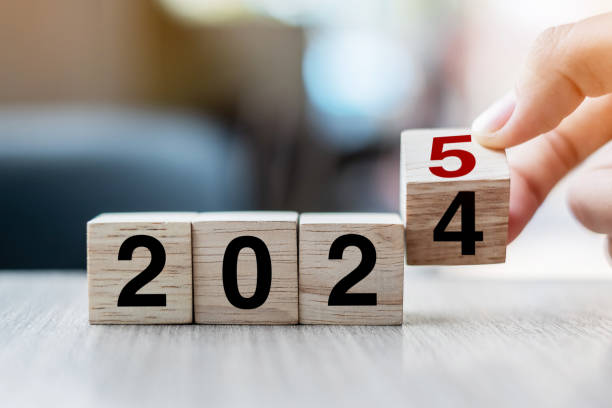 istock hand flipping block 2024 to 2025 text on table. Resolution, strategy, plan, goal, motivation, reboot, business and New Year holiday concepts 2153754023