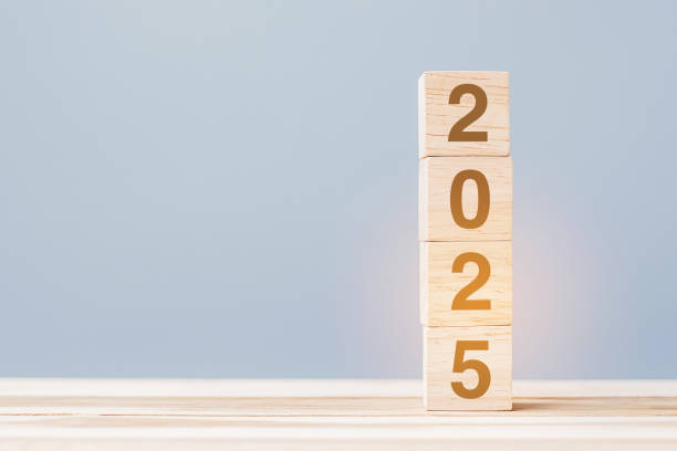 istock wooden cube block with 2025 text on table background. Resolution, plan, review, goal, start and New Year holiday concepts 2153754060
